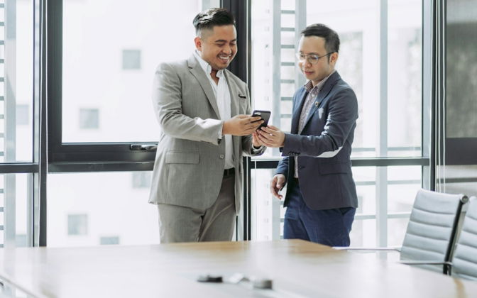 two-men-shaking-hands-in-a-conference-room.jpg two men shaking hands in a conference room